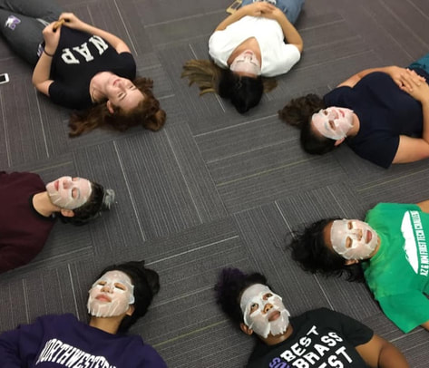 Hobartians lying together on the floor while doing spa face masks